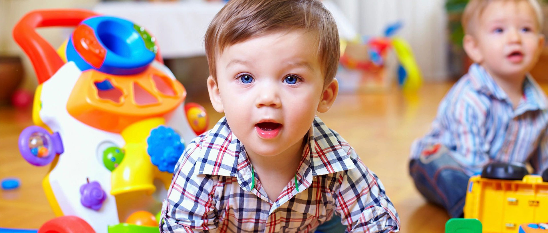 A young boy is sitting on the floor